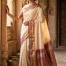 Handloom Gadwal pure tissue silk saree with intricate zari motifs and muniya borders.
