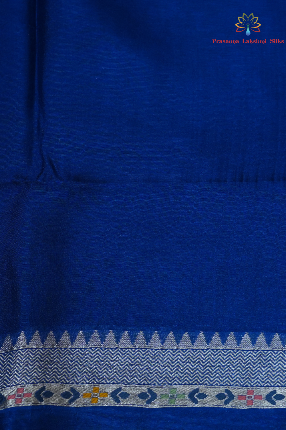 Elegant ethnic saree featuring rich floral Meenakari pallu and running blouse piece.
