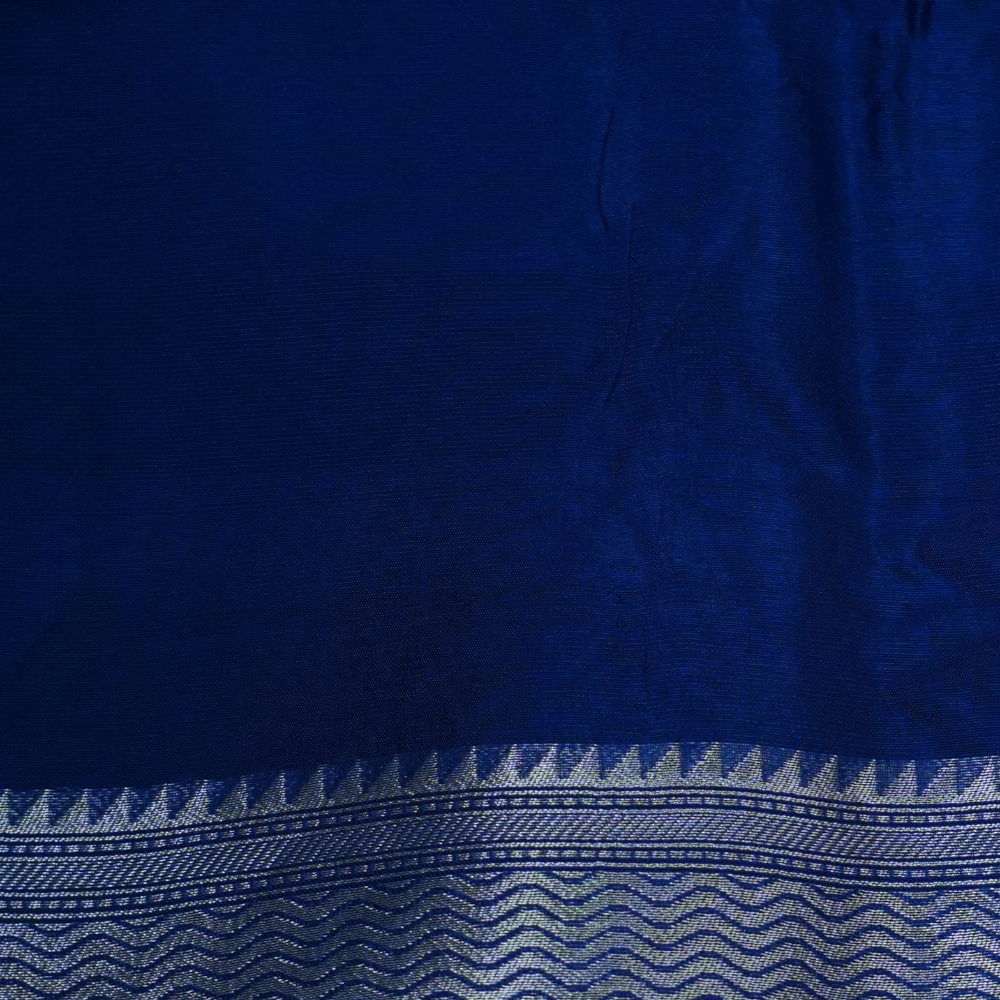 Elegant ethnic saree featuring rich floral Meenakari pallu and running blouse piece.
