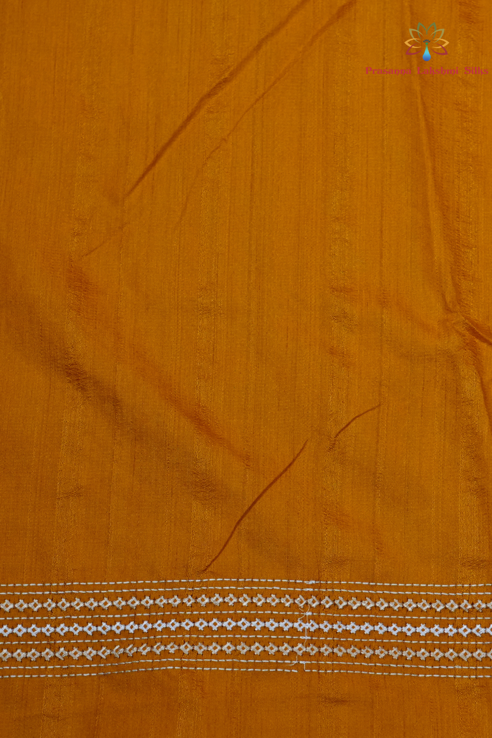 Elegant thread embroidered saree featuring rich Kutch work pallu and running blouse piece.
