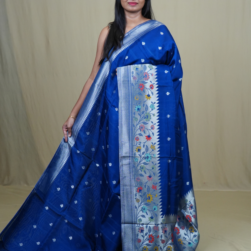 Tussar Georgette Saree with all-over silver zari woven motifs and floral Meenakari borders.
