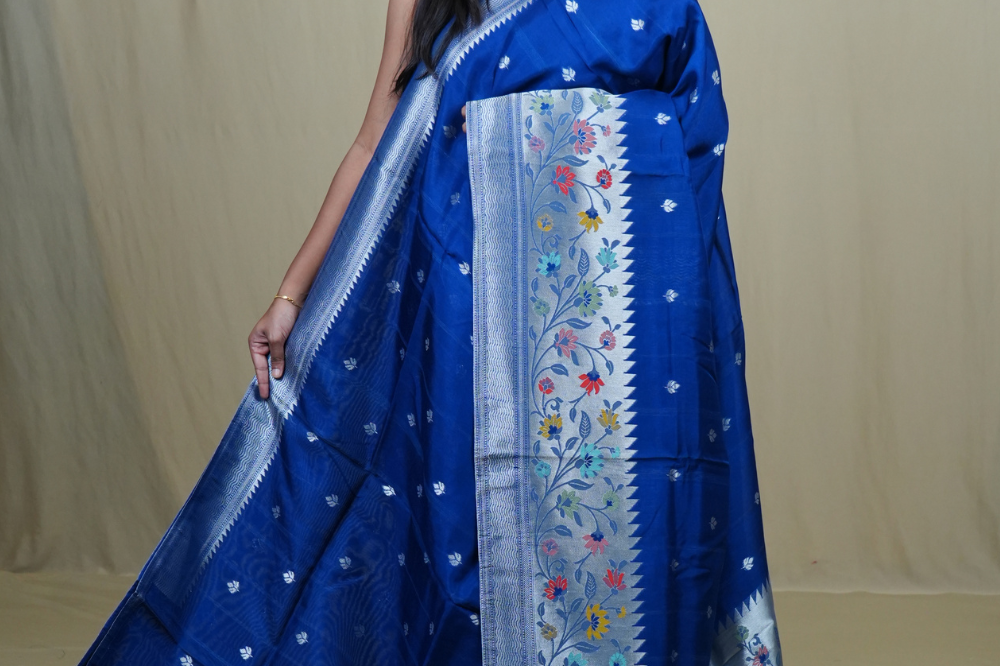 Tussar Georgette Saree with all-over silver zari woven motifs and floral Meenakari borders.
