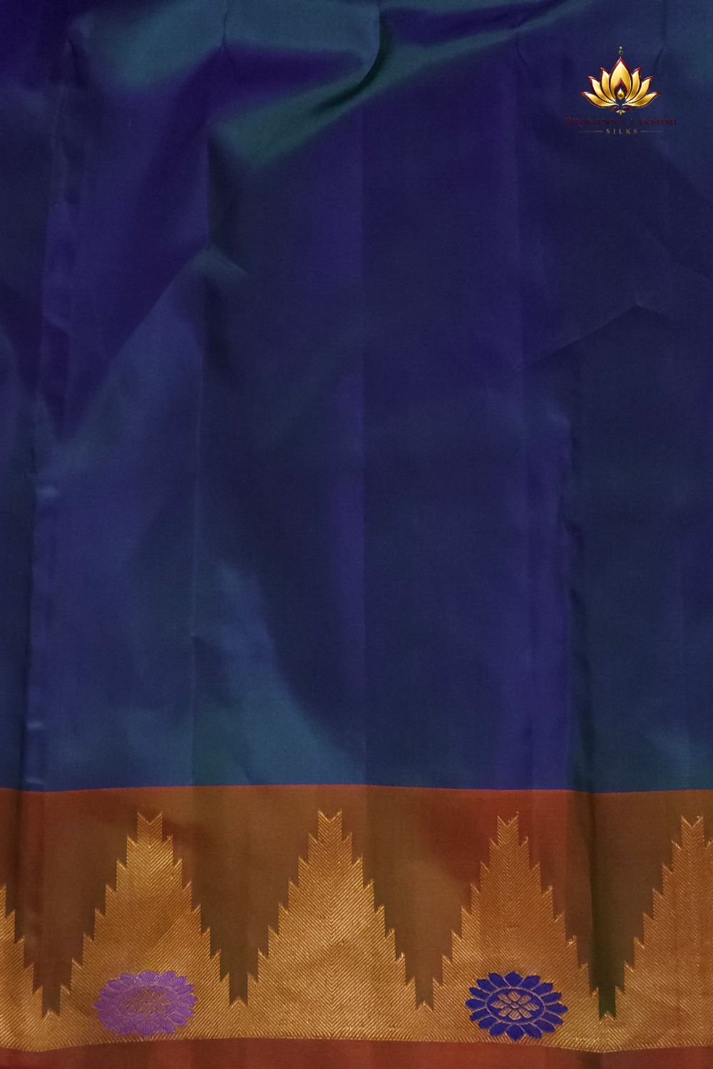Premium Gadwal Silk Saree with woven zari motifs, luxurious brocade pallu, meenakari turning border, and matching contrast blouse.
