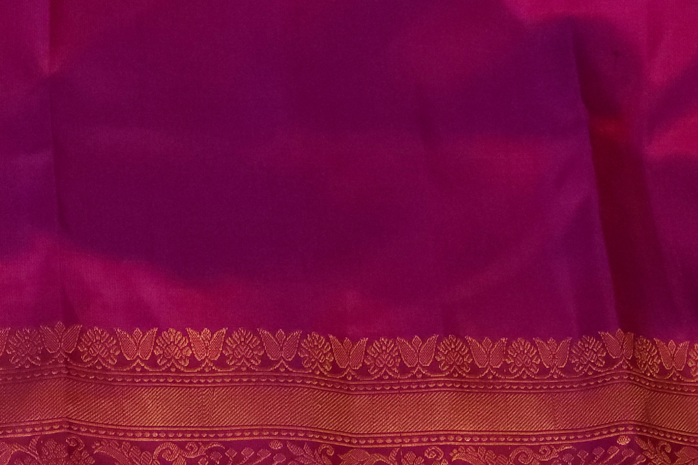 Premium Gadwal Silk Saree with woven zari motifs, luxurious brocade pallu, meenakari turning border, and matching contrast blouse.

