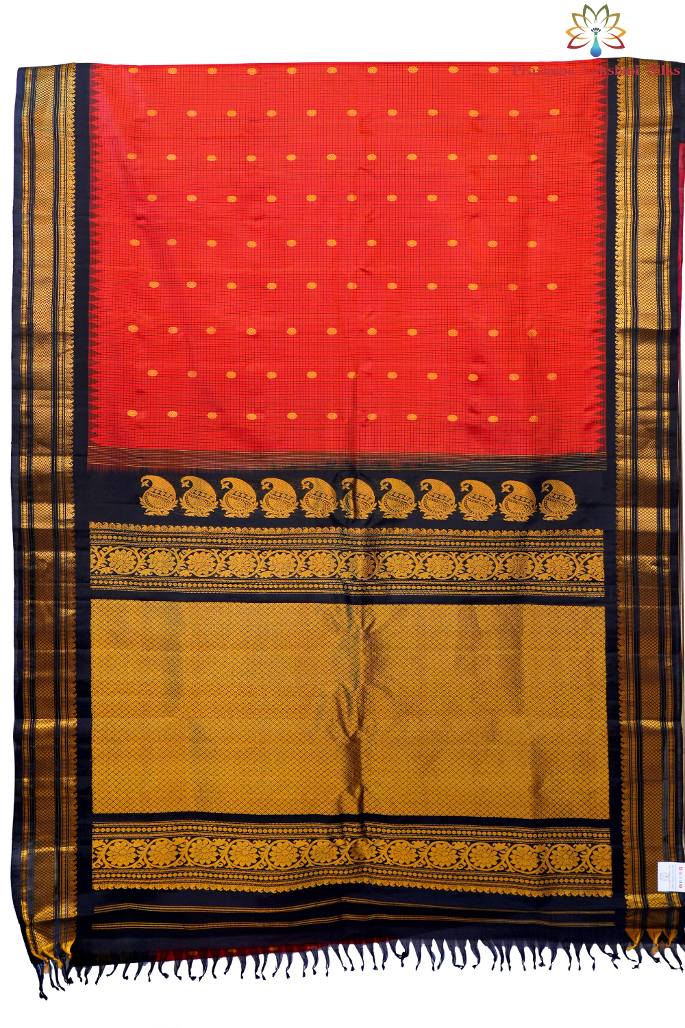 Traditional Gadwal silk saree featuring zari-woven borders and contrast blouse piece.

