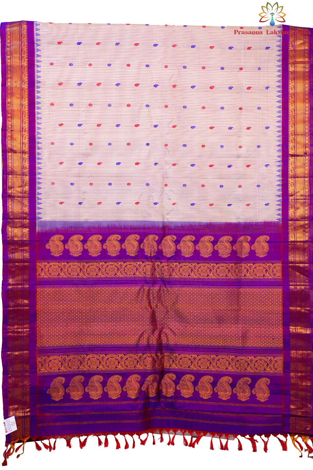 Traditional Gadwal silk saree featuring zari-woven borders and contrast blouse piece.

