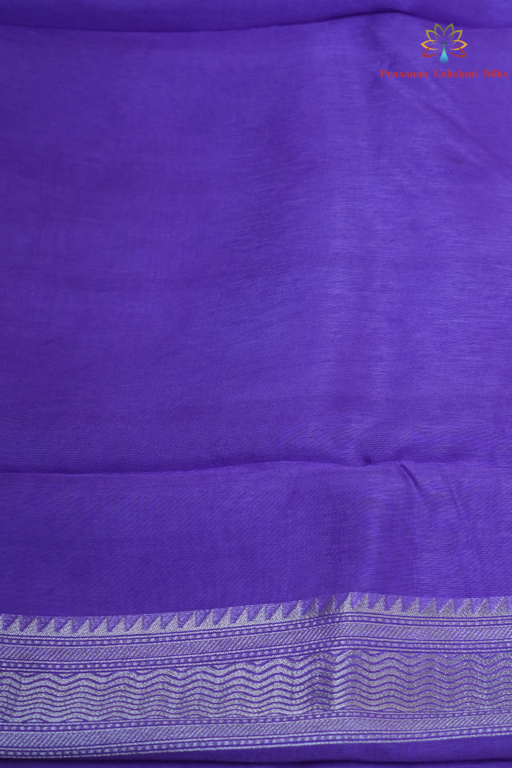 Elegant ethnic saree featuring rich floral Meenakari pallu and running blouse piece.

