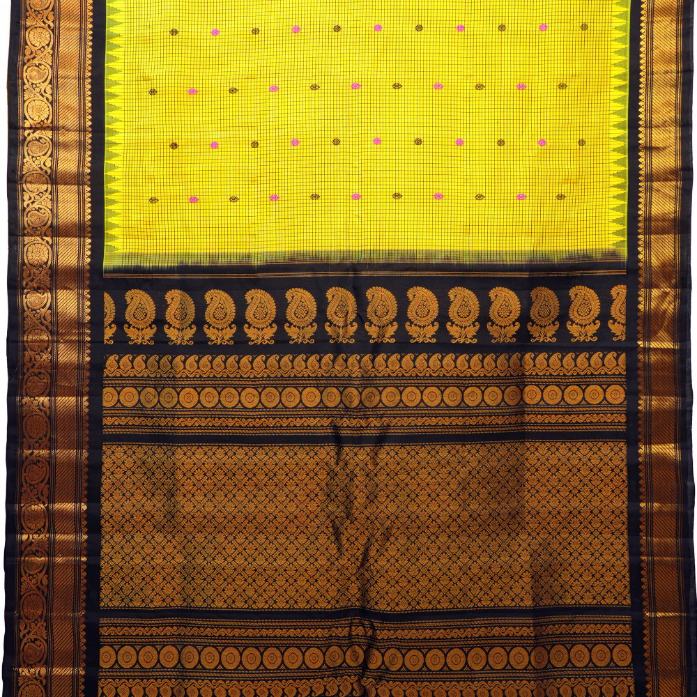 Traditional Gadwal silk saree featuring zari-woven borders and contrast blouse piece.
