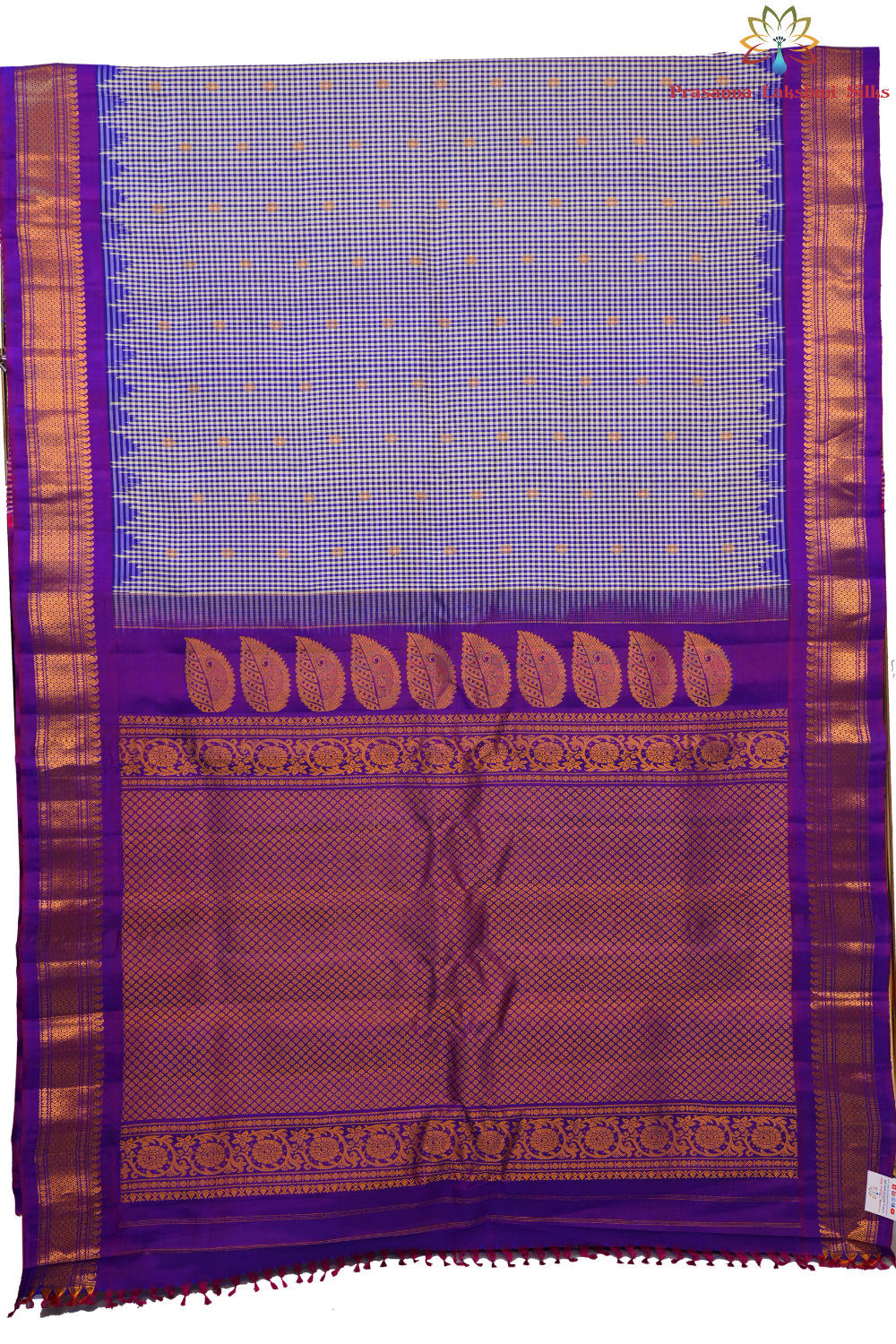 Traditional Gadwal silk saree featuring zari-woven borders and contrast blouse piece.
