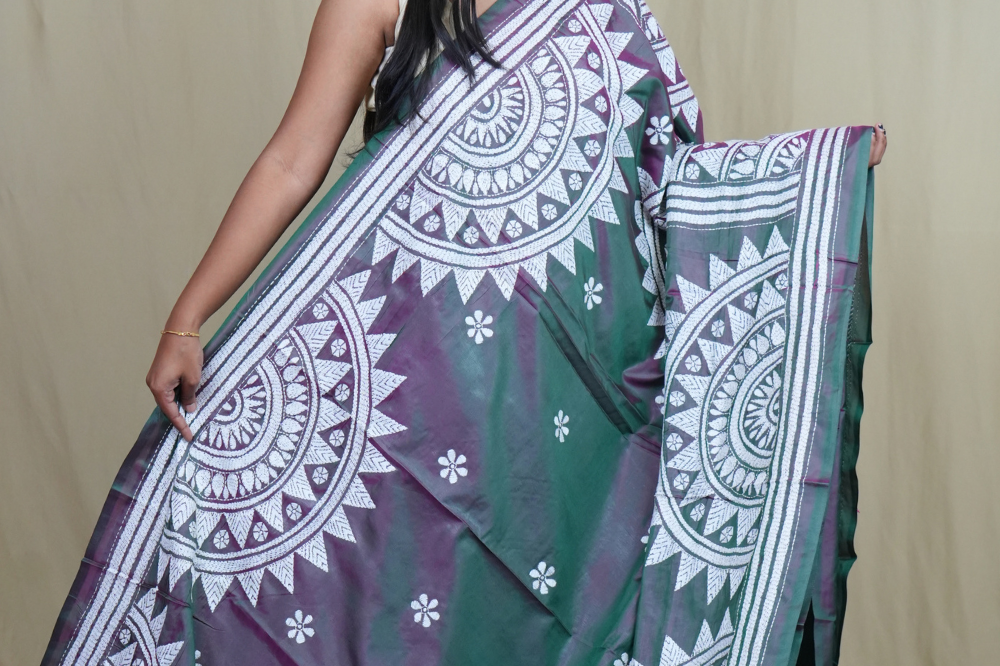 Elegant silk saree featuring Kantha work borders and detailed Kantha pallu design.
