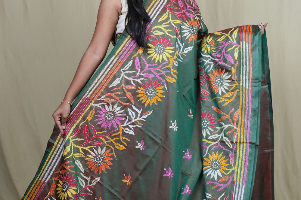 Elegant silk saree featuring Kantha work borders and detailed Kantha pallu design.
