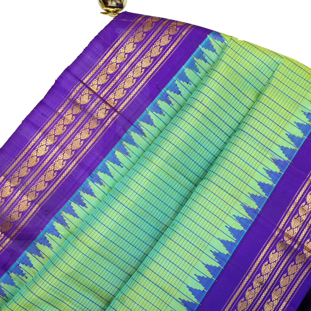 Handloom Gadwal pure silk saree with all-over zari stripes and rich tissue pallu.
