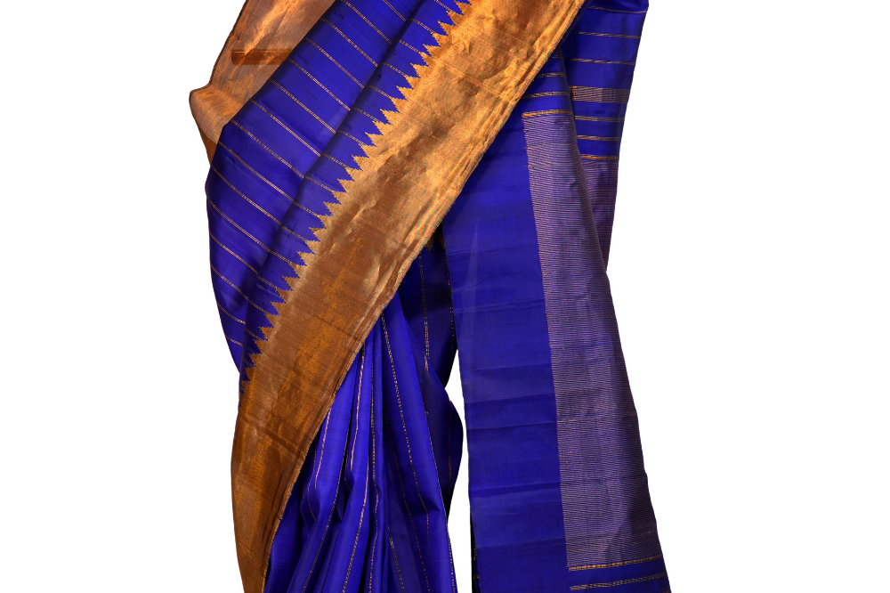Handloom Gadwal pure silk saree with all-over zari stripes and rich tissue pallu.
