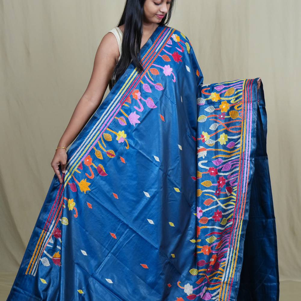 Elegant silk saree featuring Kantha work borders and detailed Kantha pallu design.
