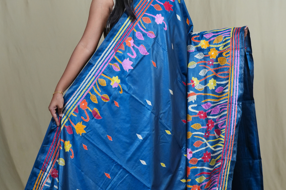 Elegant silk saree featuring Kantha work borders and detailed Kantha pallu design.
