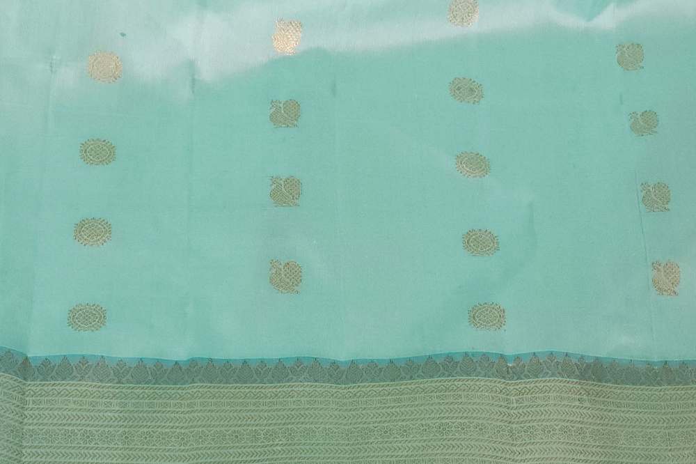 Premium Gadwal Silk Saree with woven zari motifs, luxurious brocade pallu, meenakari turning border, and matching contrast blouse.
