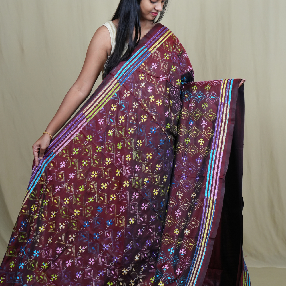 Elegant silk saree featuring Kantha work borders and detailed Kantha pallu design.
