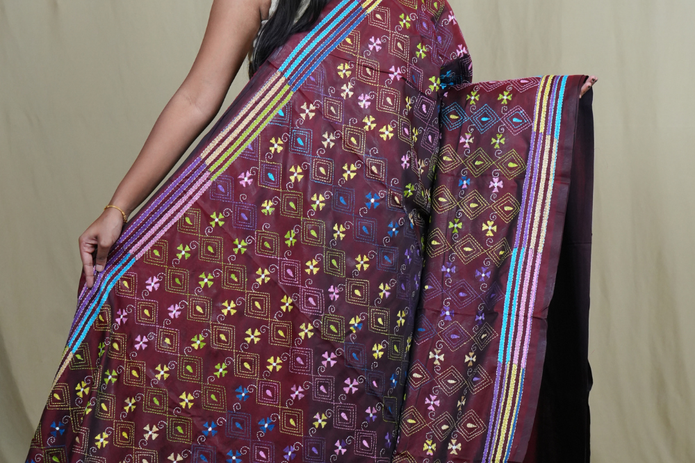 Elegant silk saree featuring Kantha work borders and detailed Kantha pallu design.
