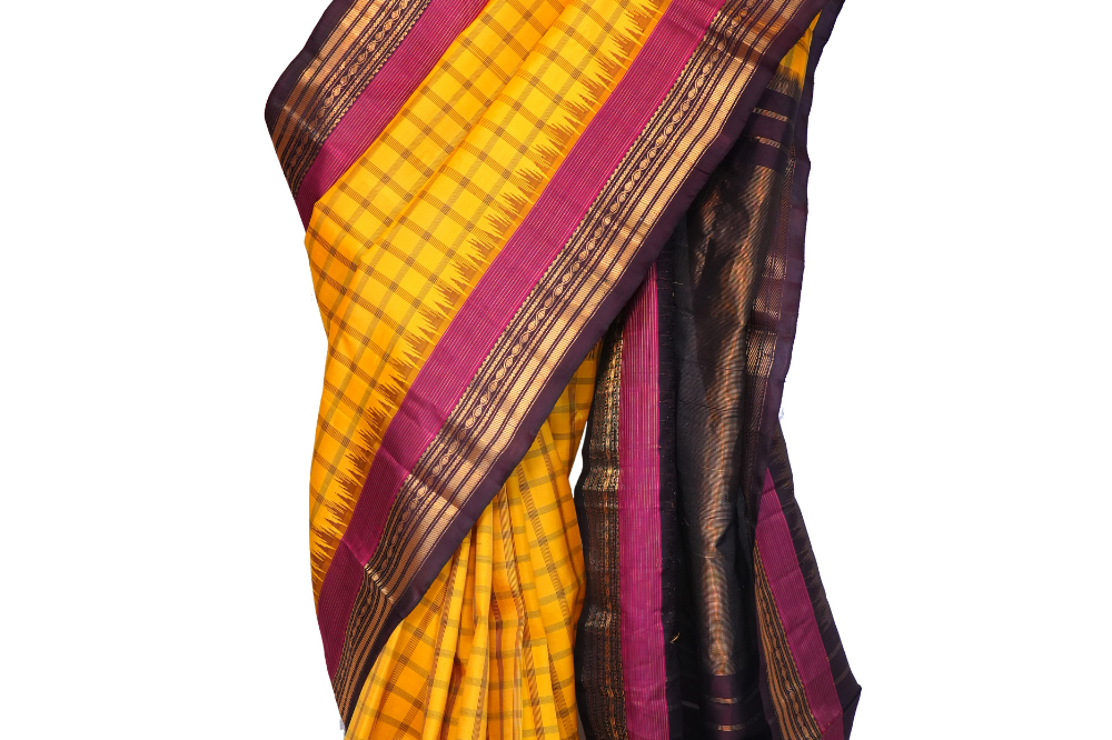 Handloom Gadwal pure silk saree with all-over zari stripes and rich tissue pallu.
