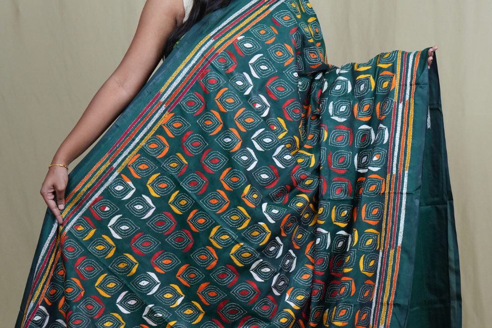 Elegant silk saree featuring Kantha work borders and detailed Kantha pallu design.
