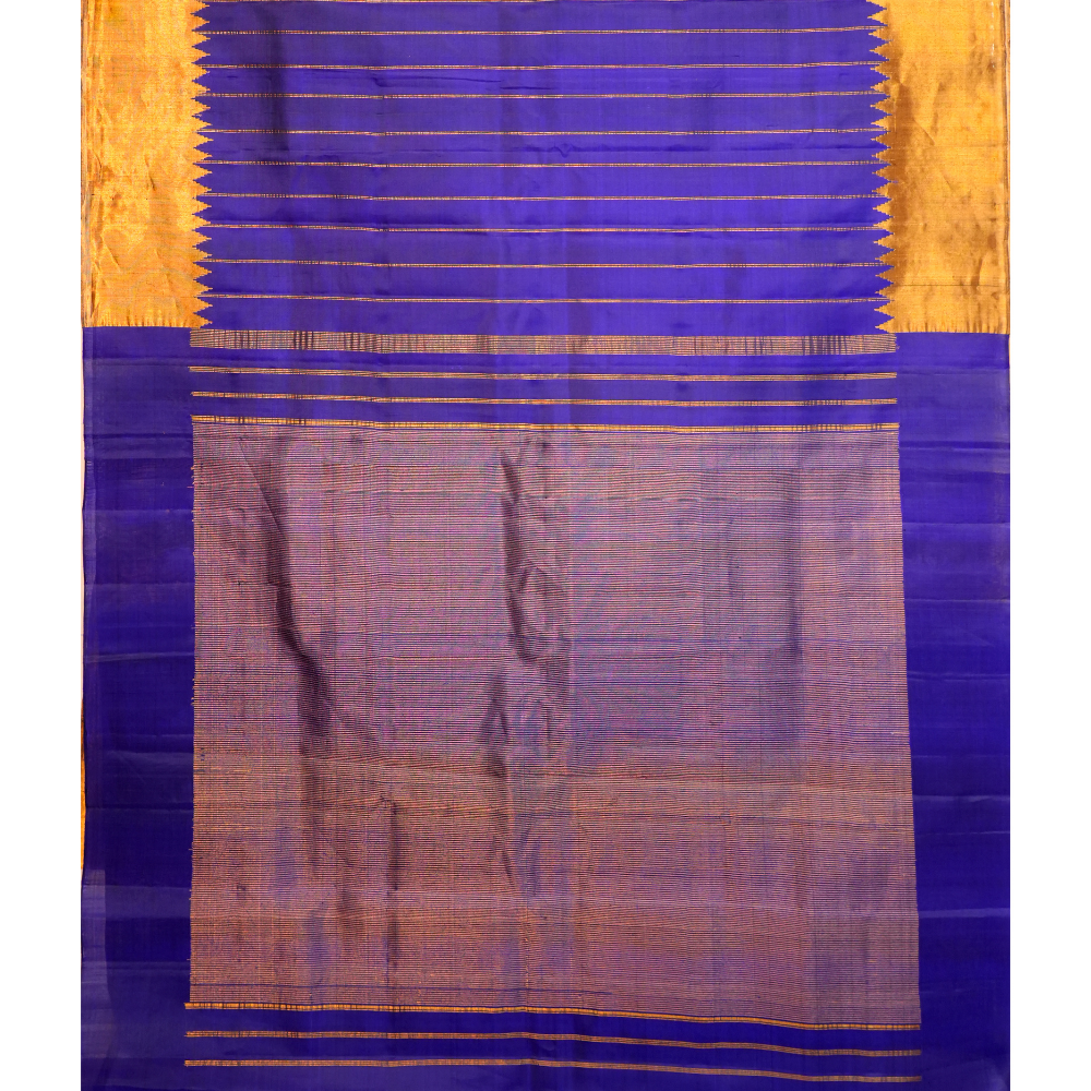 Traditional Gadwal silk saree featuring zari woven temple borders and contrast blouse.
