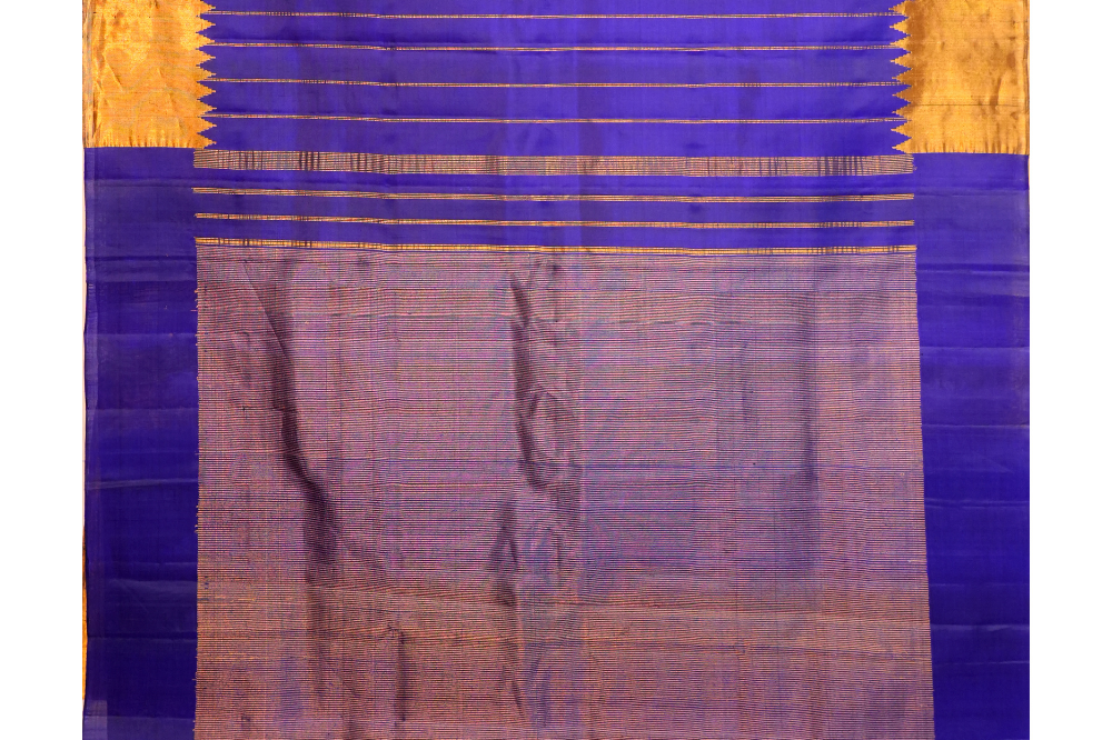 Traditional Gadwal silk saree featuring zari woven temple borders and contrast blouse.

