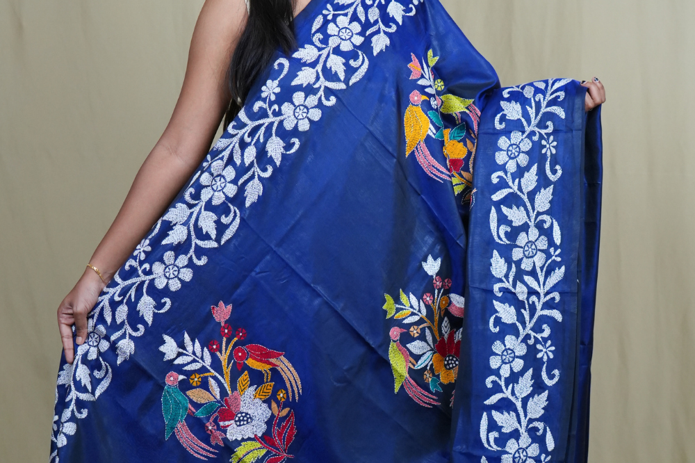 Elegant silk saree featuring Kantha work borders and detailed Kantha pallu design.
