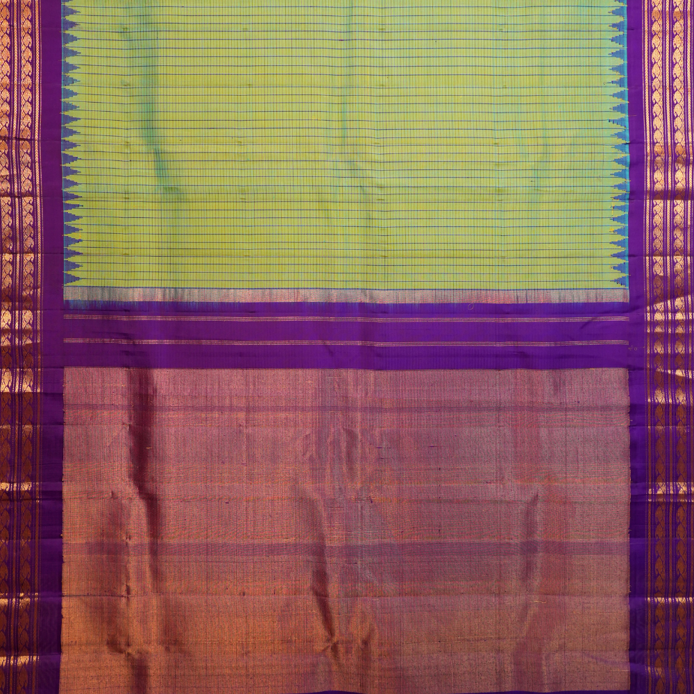 Traditional Gadwal silk saree featuring zari woven temple borders and contrast blouse.

