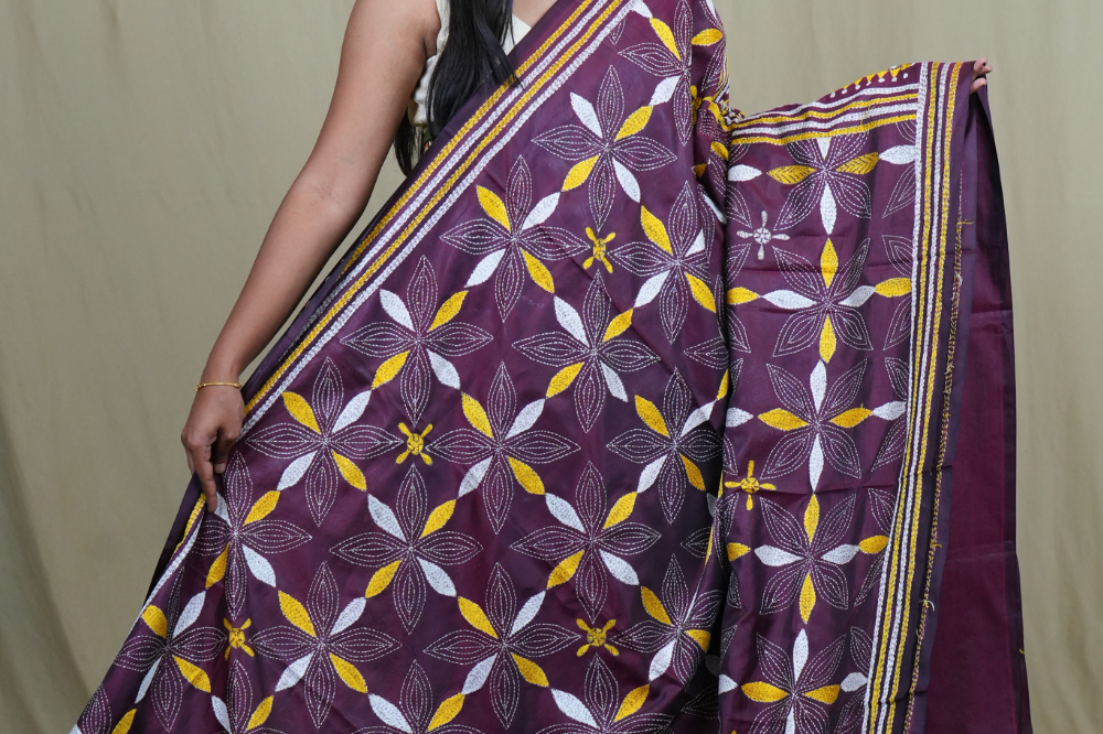 Elegant silk saree featuring Kantha work borders and detailed Kantha pallu design.
