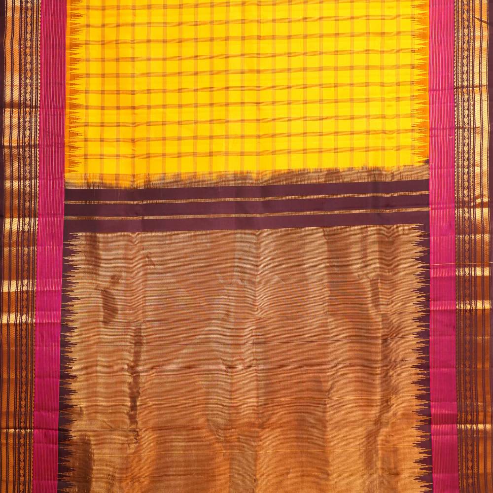 Traditional Gadwal silk saree featuring zari woven temple borders and contrast blouse.

