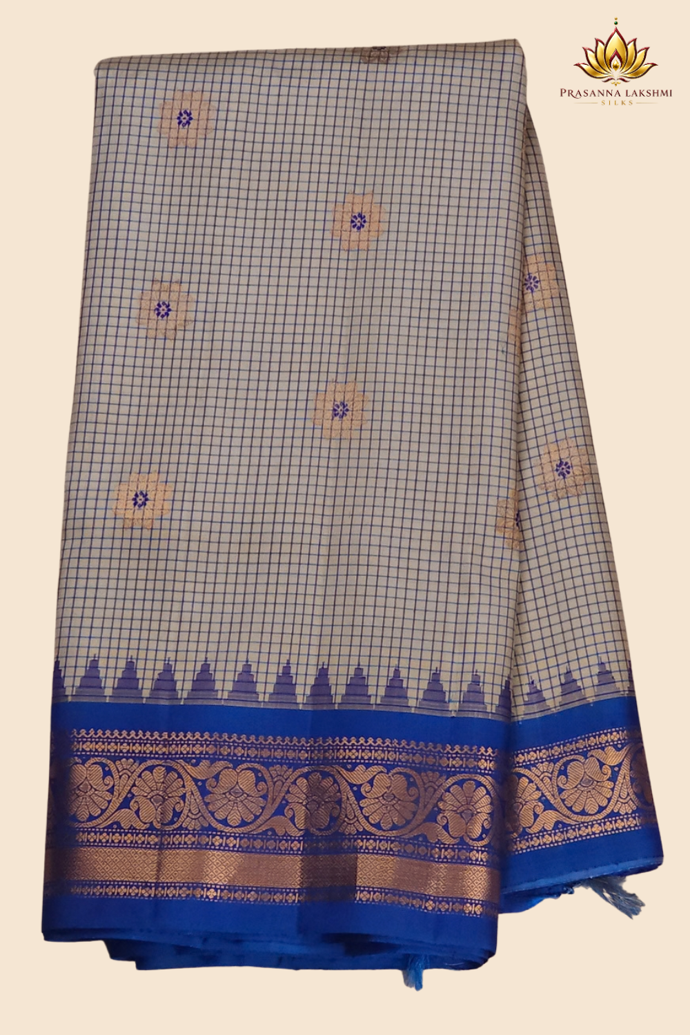 Traditional Gadwal silk saree featuring zari-woven borders and contrast blouse piece.
