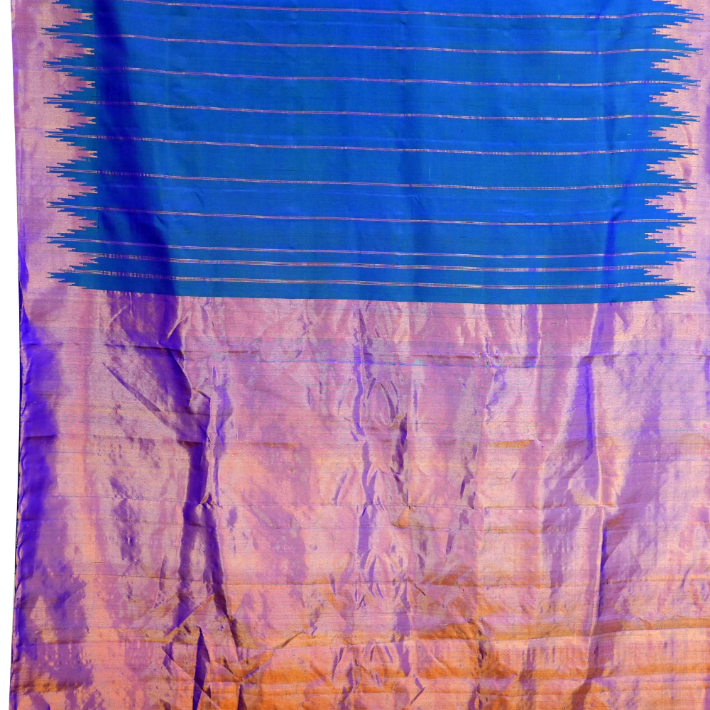 Traditional Gadwal silk saree featuring zari woven temple borders and contrast blouse.
