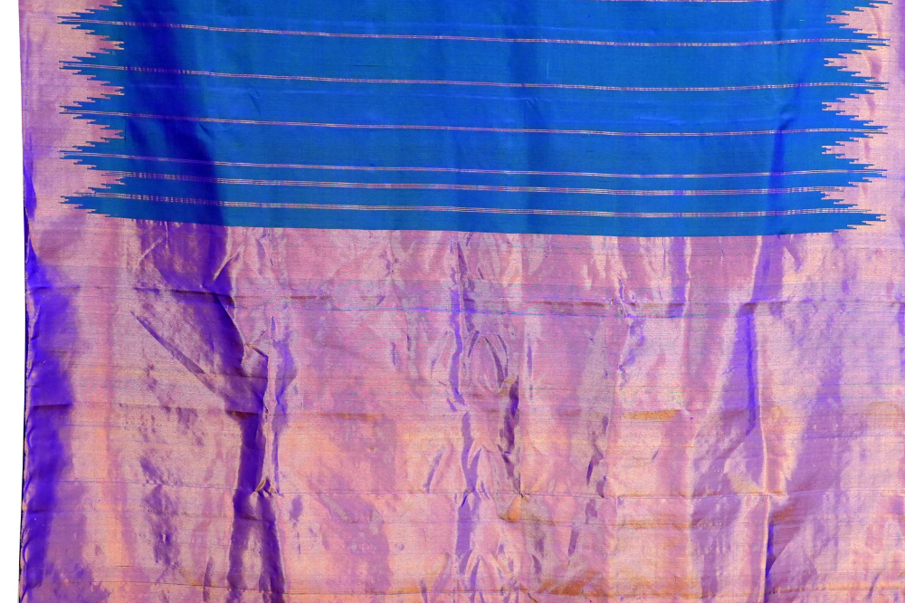 Traditional Gadwal silk saree featuring zari woven temple borders and contrast blouse.
