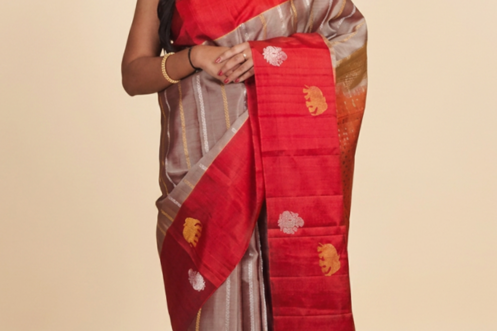Pure handloom Gadwal silk saree with all-over zari motifs and intricate turning borders
