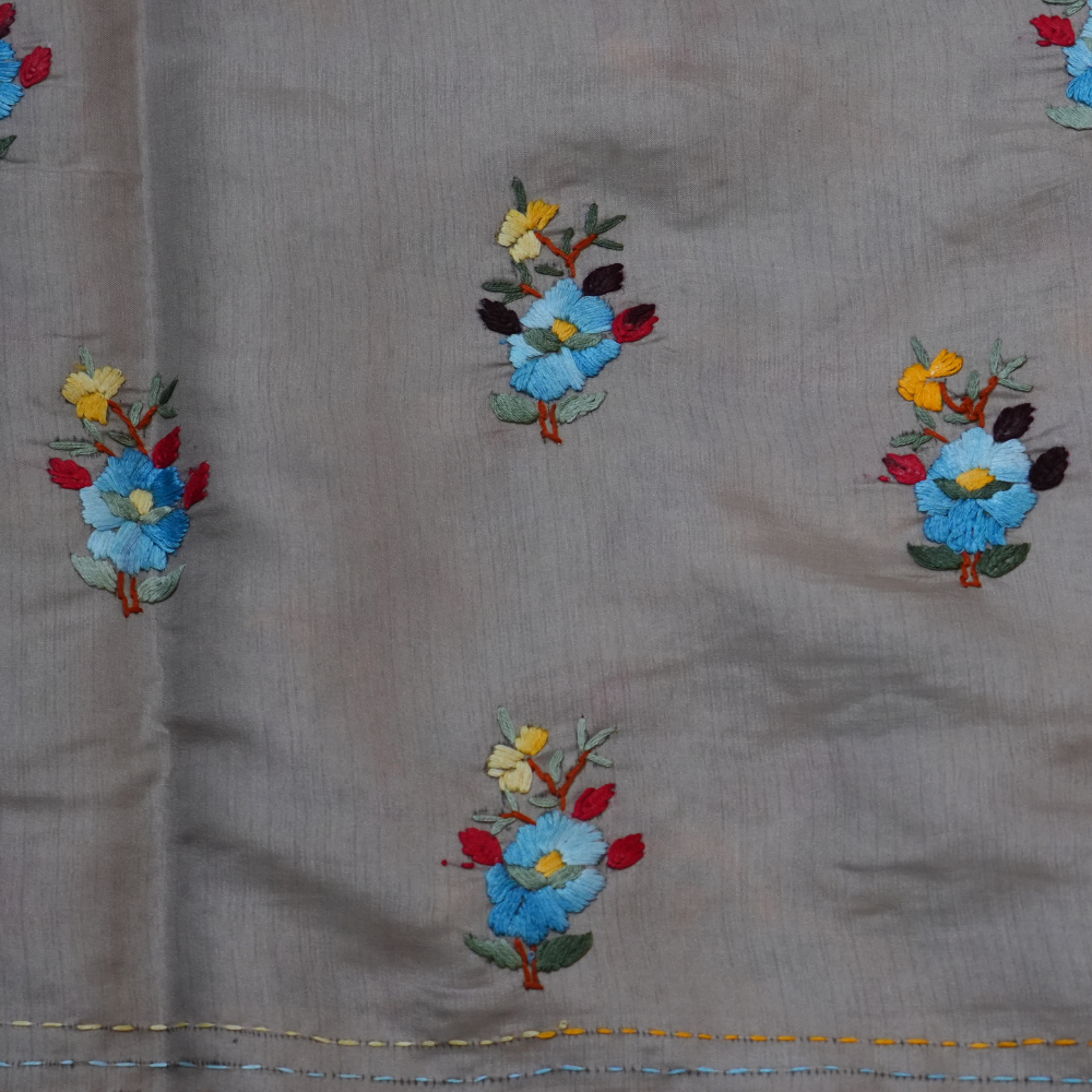 Elegant Tussar saree featuring thread woven Parsi work borders and running blouse piece.
