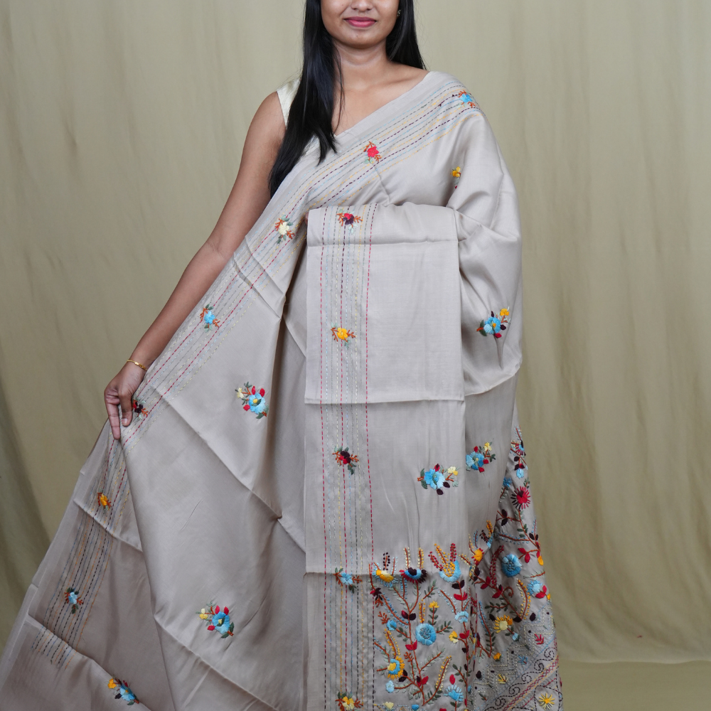 Semi Tussar saree with all-over thread woven motifs and rich Parsi work pallu.