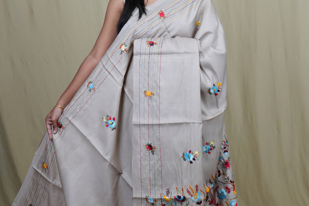 Semi Tussar saree with all-over thread woven motifs and rich Parsi work pallu.