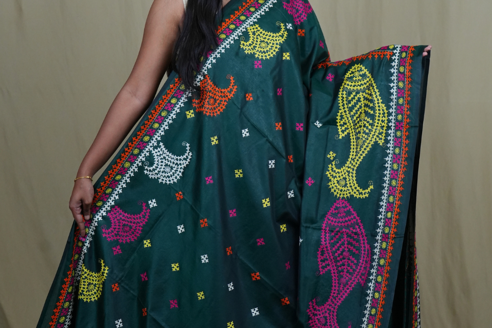 Elegant silk saree featuring Kantha work borders and detailed Kantha pallu design.
