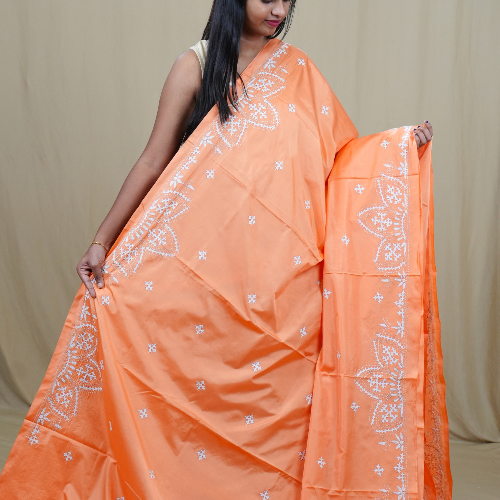 Traditional semi silk saree featuring beautiful hand Kutch work borders and artistic design.
