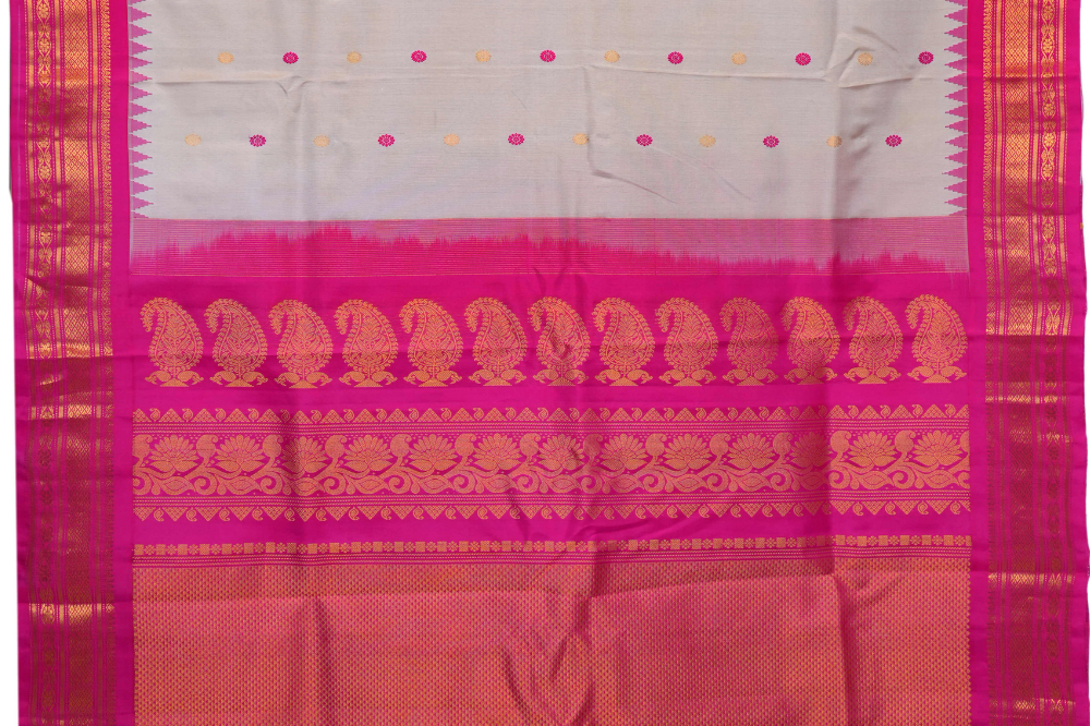 Handloom Gadwal pure silk saree with intricate small zari motifs and rich woven pallu.
