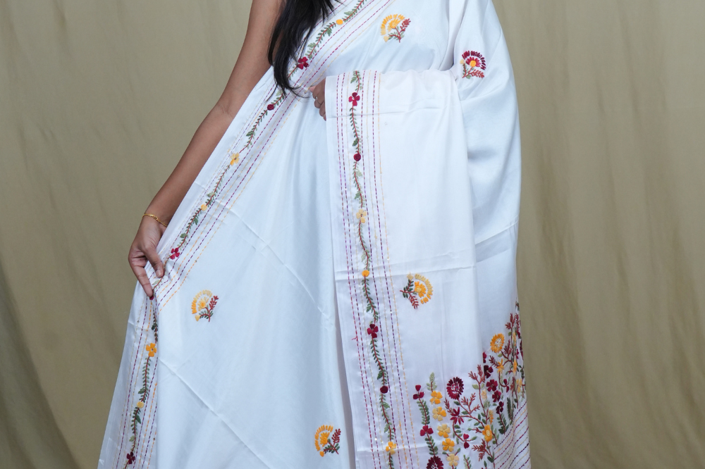 Semi Tussar saree with all-over thread woven motifs and rich Parsi work pallu.
