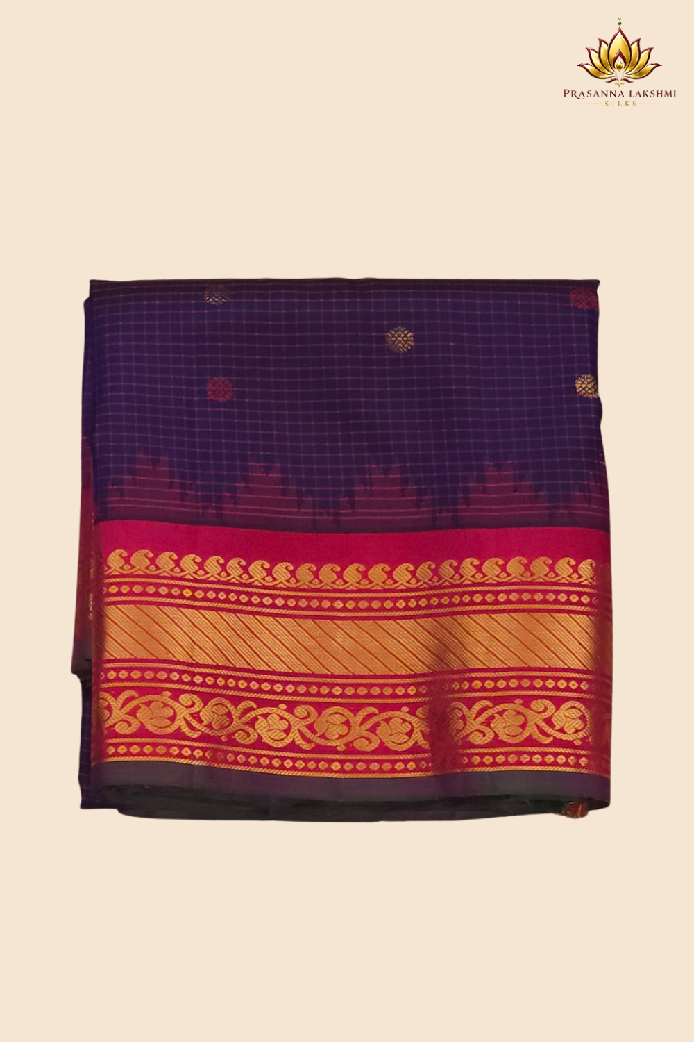 Traditional Gadwal silk saree featuring zari-woven borders and contrast blouse piece.
