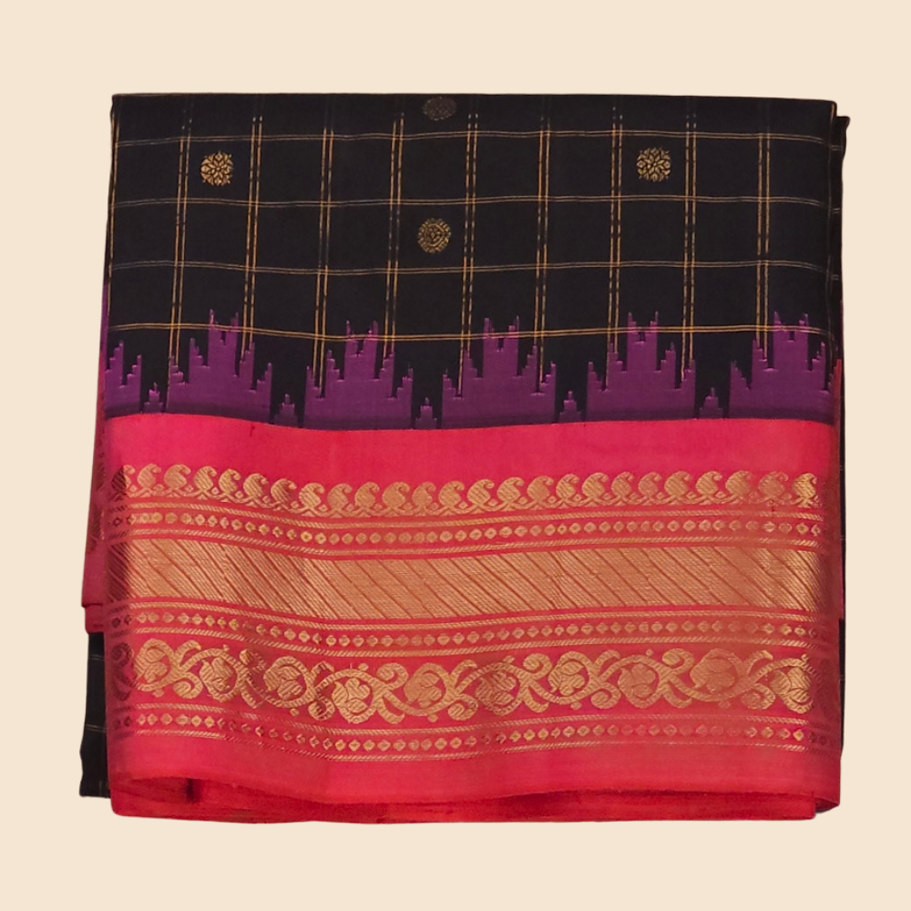 Traditional Gadwal silk saree featuring zari-woven borders and contrast blouse piece.

