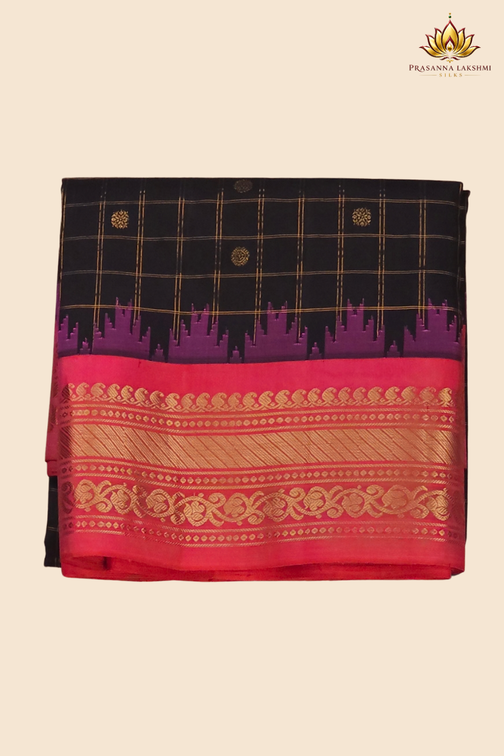 Traditional Gadwal silk saree featuring zari-woven borders and contrast blouse piece.
