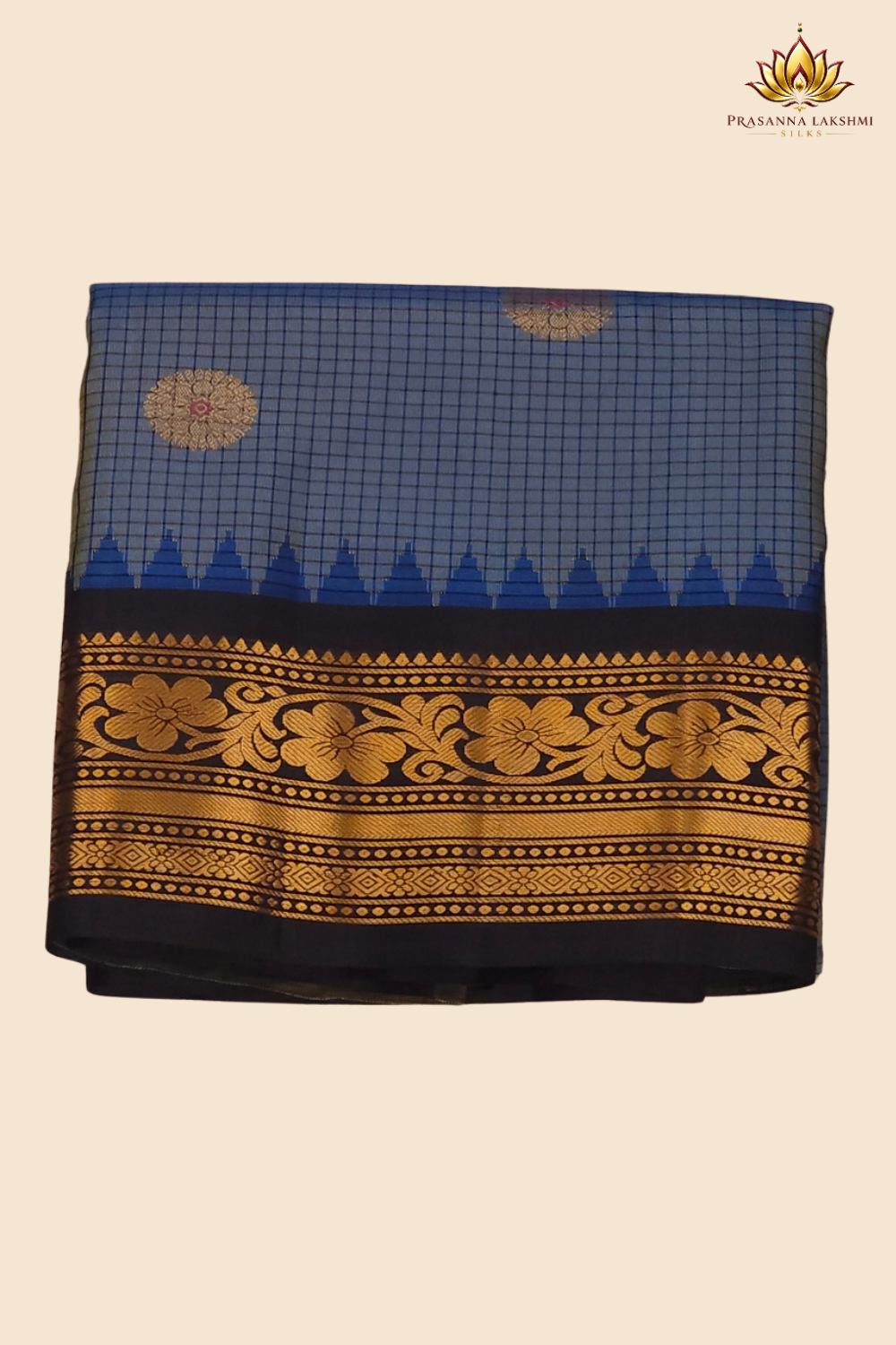 Traditional Gadwal silk saree featuring zari-woven borders and contrast blouse piece.
