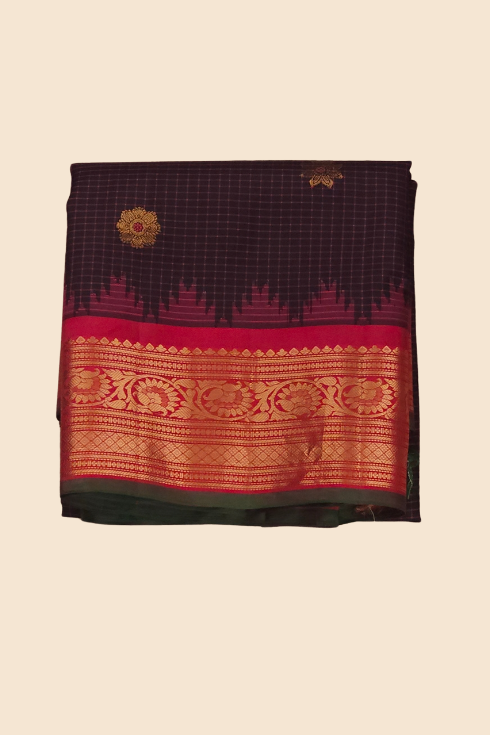 Traditional Gadwal silk saree featuring zari-woven borders and contrast blouse piece.
