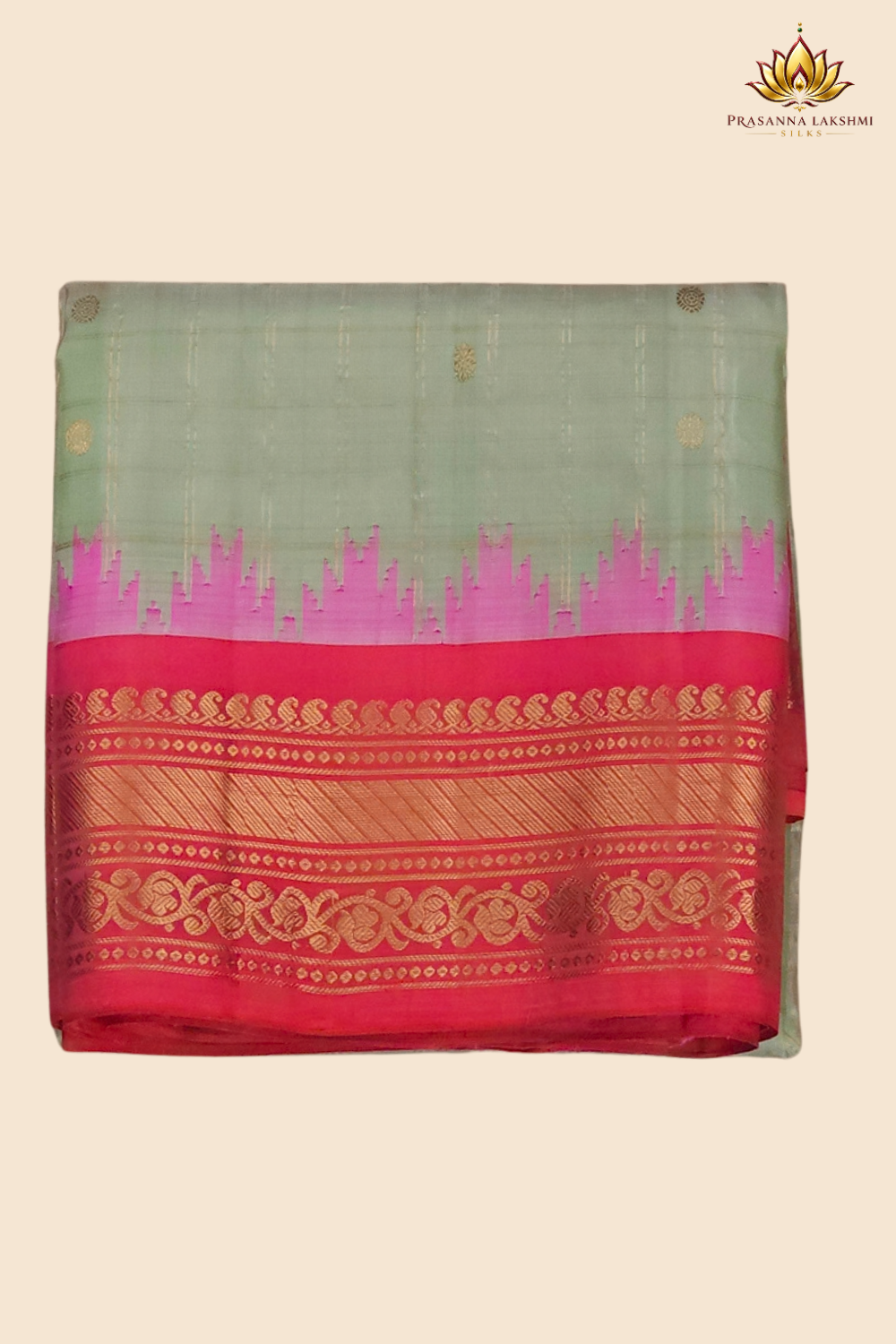 Traditional Gadwal silk saree featuring zari-woven borders and contrast blouse piece.
