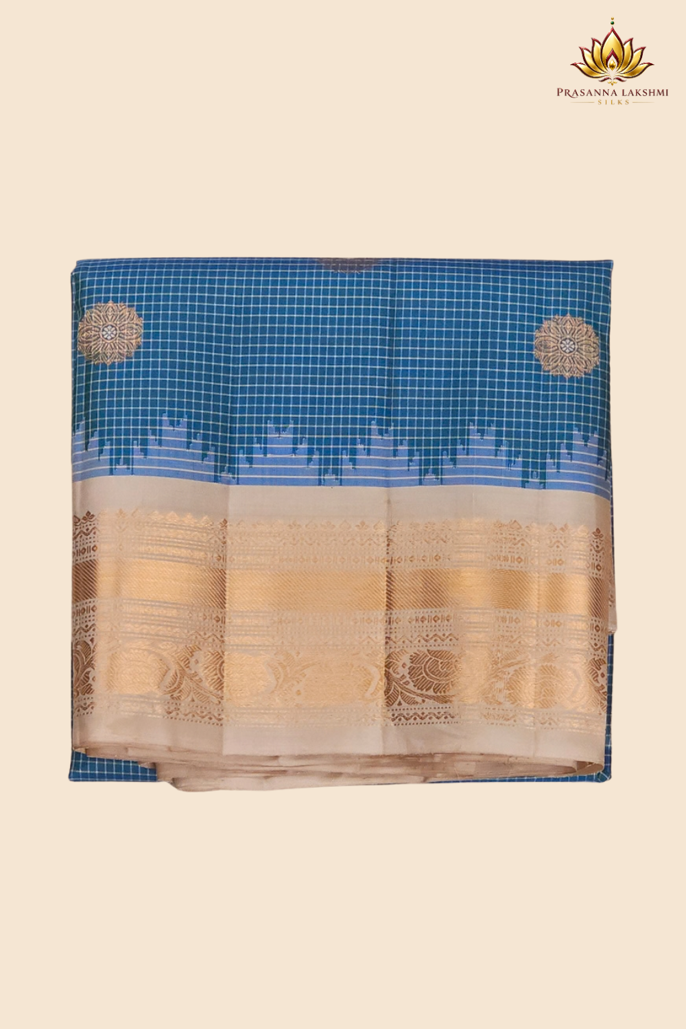 Traditional Gadwal silk saree featuring zari-woven borders and contrast blouse piece.
