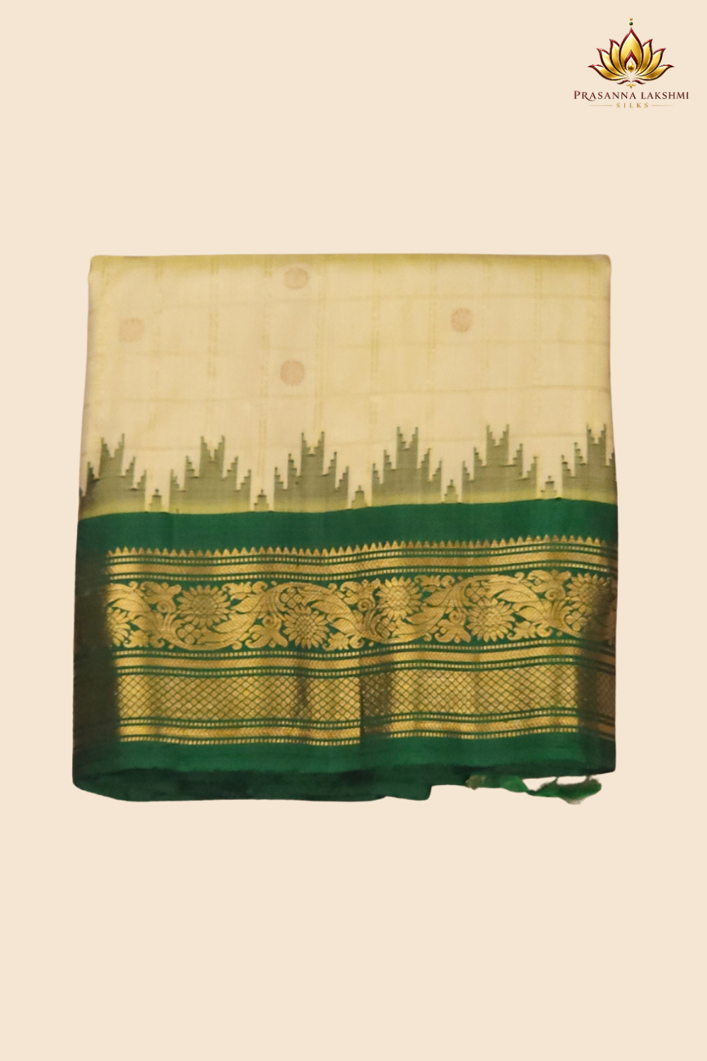 Traditional Gadwal silk saree featuring zari-woven borders and contrast blouse piece.
