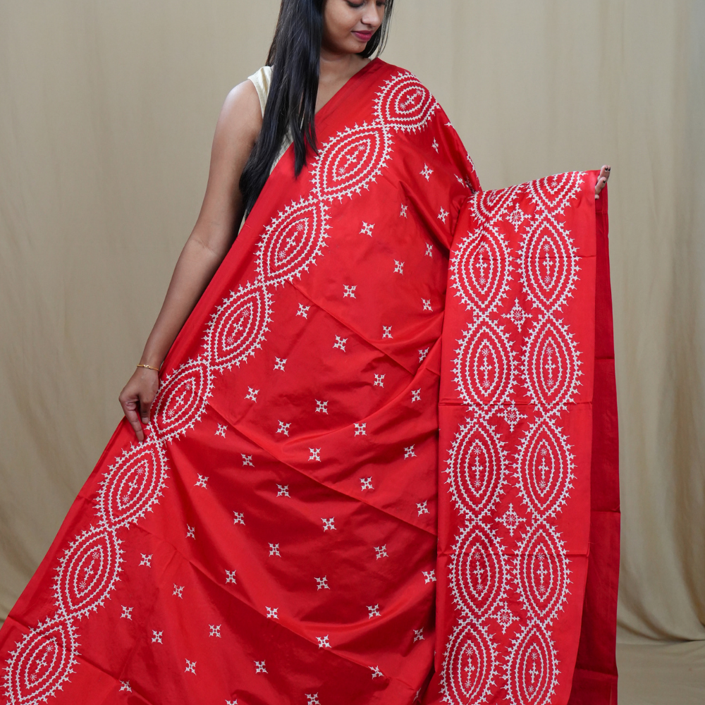 Traditional semi silk saree featuring beautiful hand Kutch work borders and artistic design.
